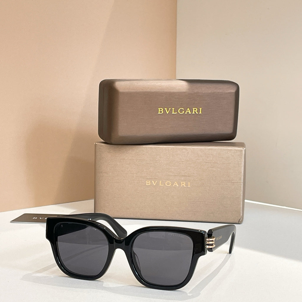 Black oversized sunglasses with bold frames and dark tinted lenses, metal hinge detail.