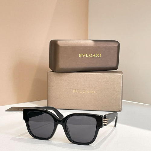 Black oversized sunglasses with bold frames and dark tinted lenses, metal hinge detail.
