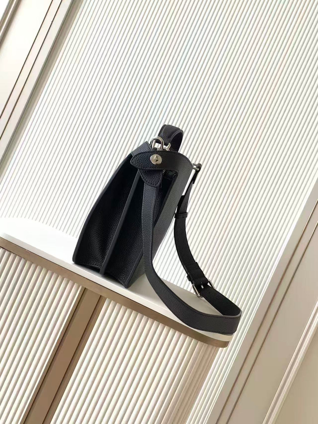 Black leather Fendi handbag with side strap and top handle, front view