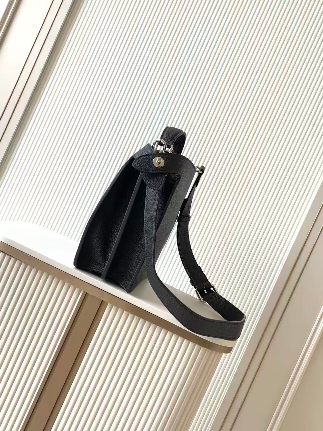 Black leather Fendi handbag with side strap and top handle, front view