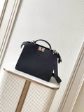 Black leather Fendi handbag with top handle and crossbody strap, front logo plaque
