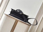 Black leather Fendi handbag with top clasp handle and shoulder strap, side view
