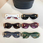 Versace sunglasses set with gold emblems in multiple colors, beside black case