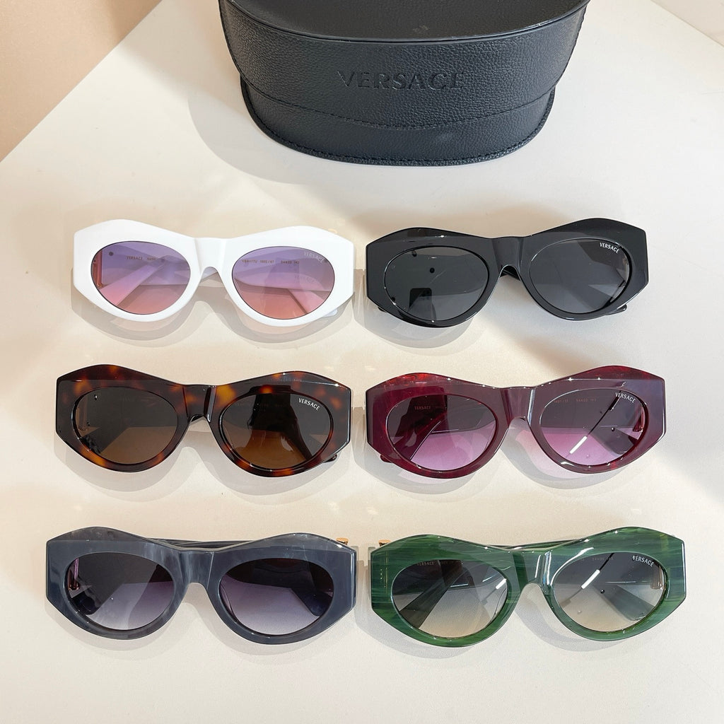 Six Versace sunglasses with assorted frames and lenses, beside black case