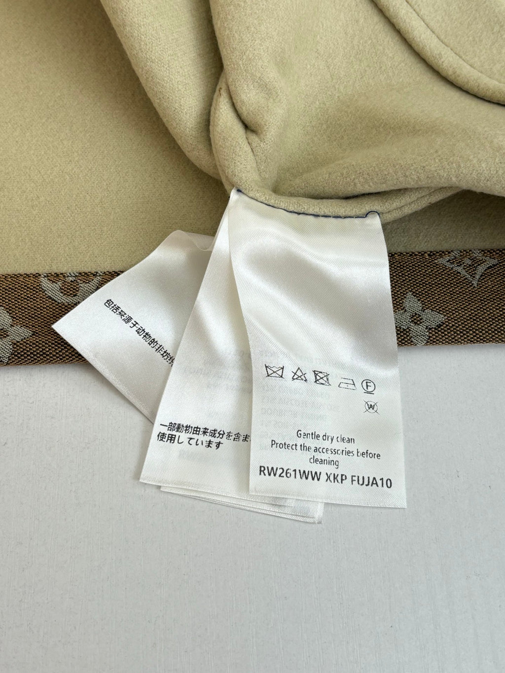Louis Vuitton jacket care tags attached to beige inner lining fabric