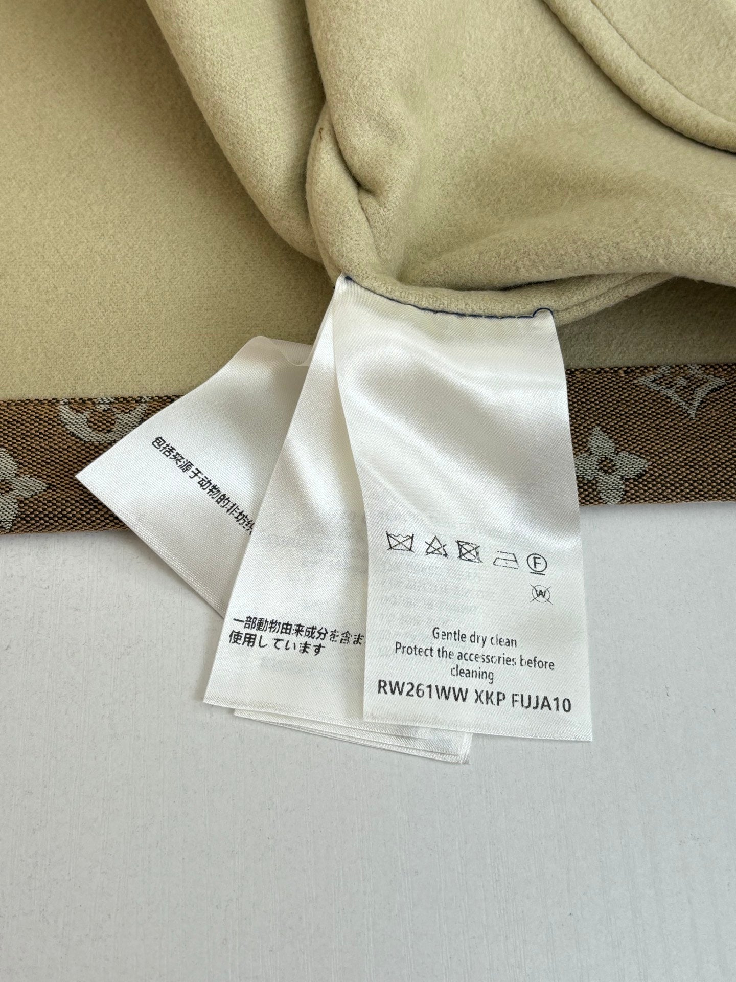 Louis Vuitton jacket care tags attached to beige inner lining fabric
