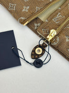 Louis Vuitton jacket accessories: gold zipper pull and round key charm on tags