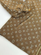 Louis Vuitton monogram jacket sleeve close-up, brown fabric with all-over pattern