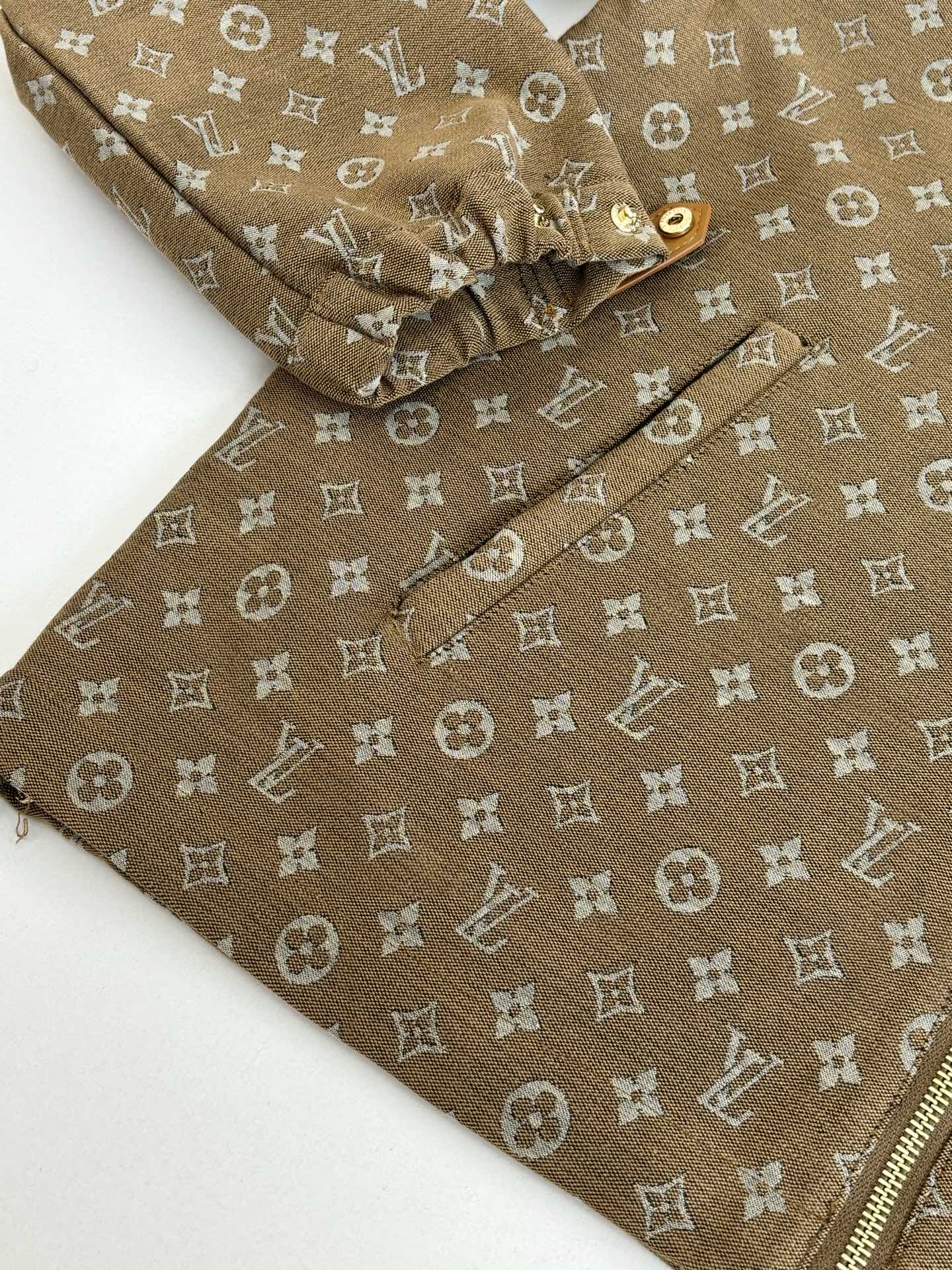 Louis Vuitton monogram jacket sleeve close-up, brown fabric with all-over pattern