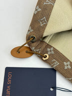 Louis Vuitton hood tie and monogram cuff close-up with tan leather end piece