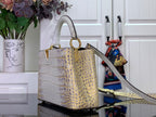 Louis Vuitton handbag with gold-tone ring handle, croc-embossed white body