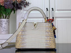 Louis Vuitton handbag in white and gold, croc-embossed with top handle and flap closure
