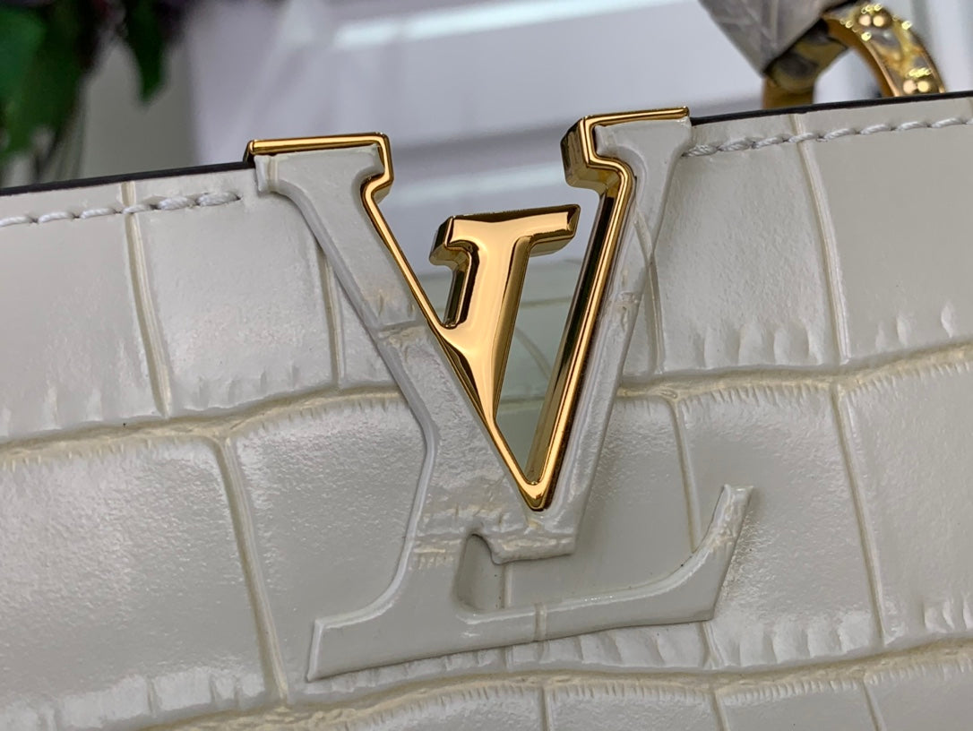 Louis Vuitton V logo on white croc-embossed flap, gold-tone emblem