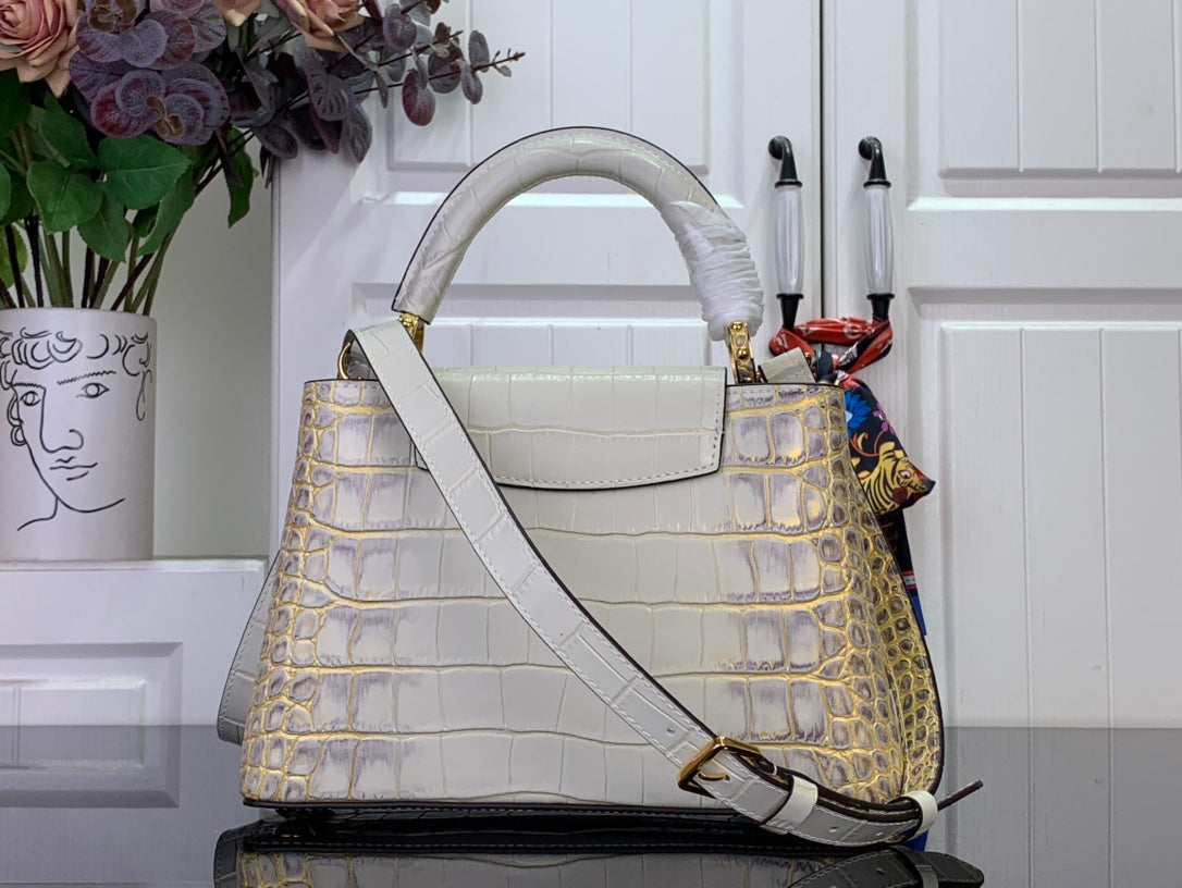 Louis Vuitton handbag with white strap, croc-embossed texture and gold-tone hardware
