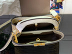 Louis Vuitton handbag interior open, showing white lining and inner zip pocket