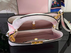 Louis Vuitton open tote bag showing pink fabric interior, croc texture, gold trim.