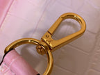 Louis Vuitton gold D-ring hardware with pink leather strap loop.