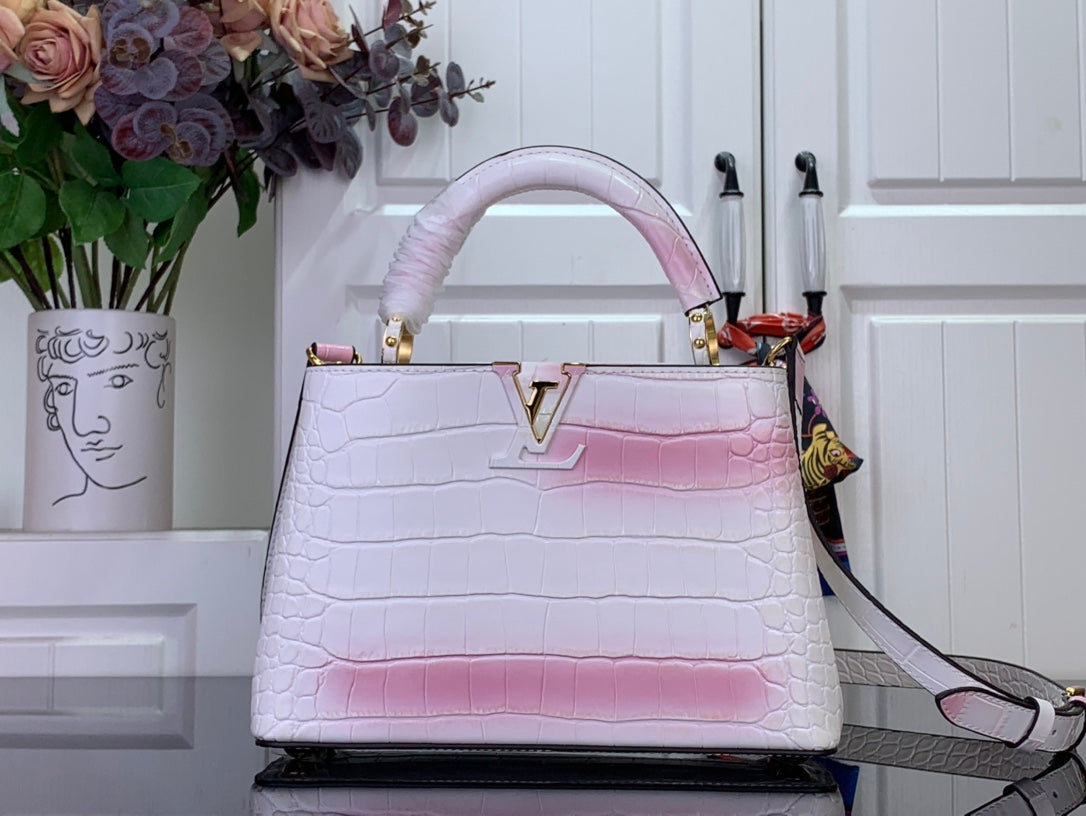 Louis Vuitton tote bag with pink-and-white croc embossed leather, gold LV clasp.
