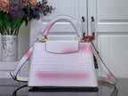 Louis Vuitton tote bag with pink ombre croc texture and shoulder strap, gold details.