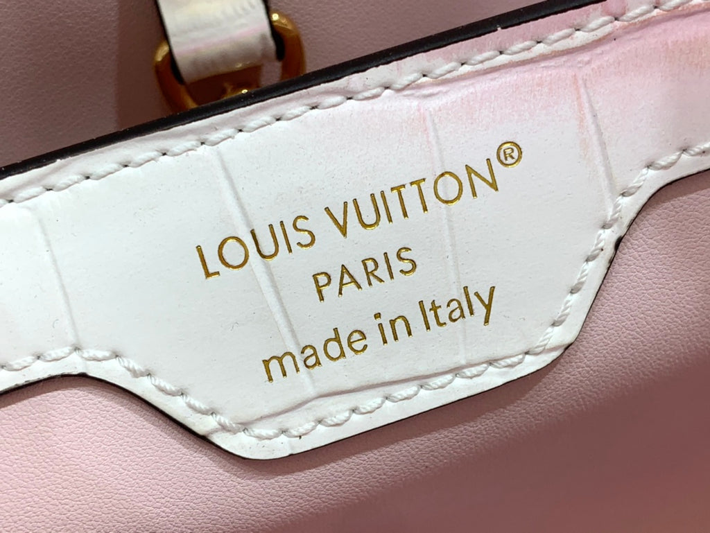 Louis Vuitton leather bag patch reading 'LOUIS VUITTON PARIS' and 'made in Italy'.
