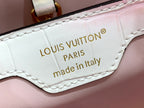 Louis Vuitton leather bag patch reading 'LOUIS VUITTON PARIS' and 'made in Italy'.