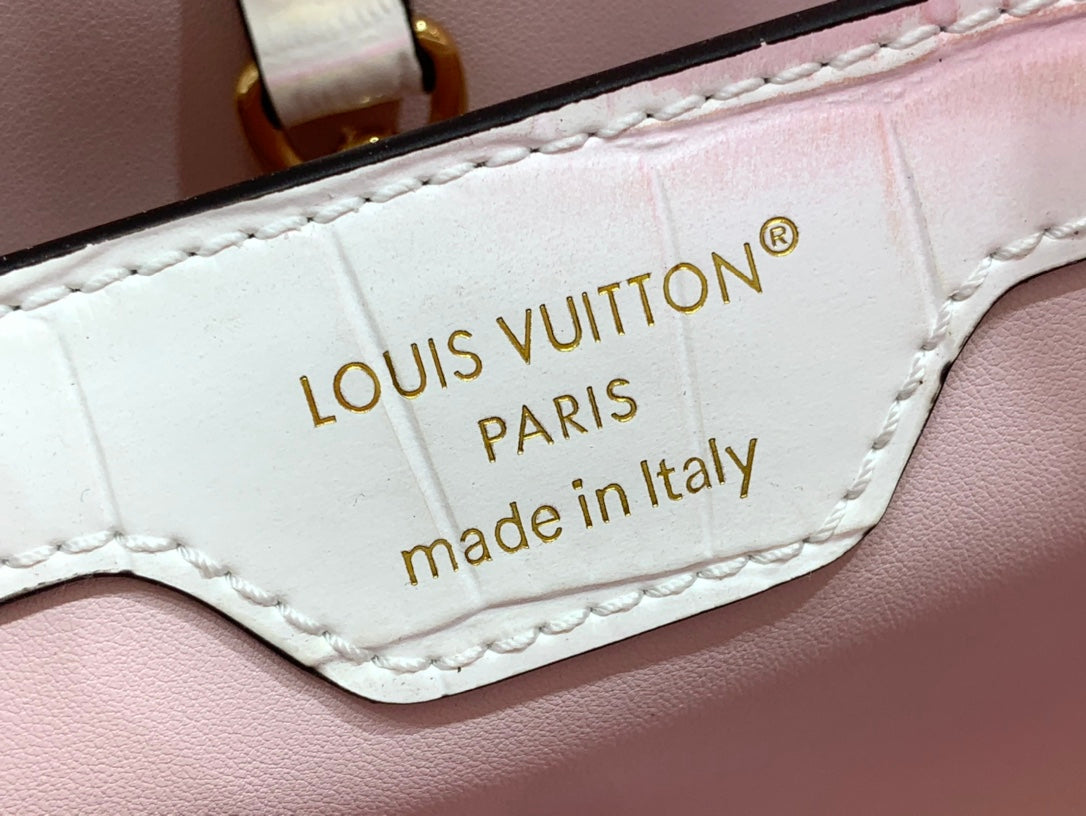 Louis Vuitton leather bag patch reading 'LOUIS VUITTON PARIS' and 'made in Italy'.