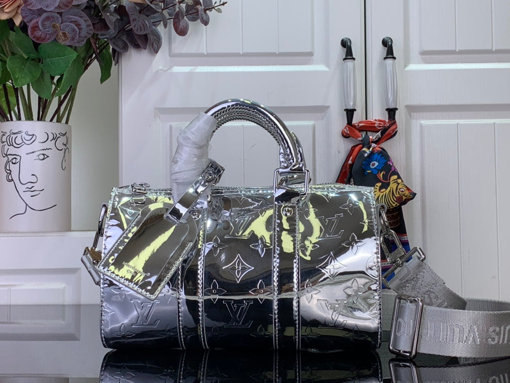 Silver Louis Vuitton monogram handbag with top handles and crossbody strap