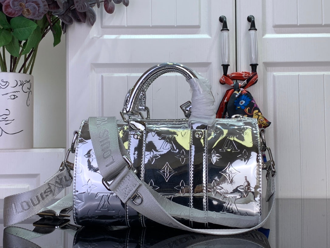 Silver Louis Vuitton monogram handbag with wide strap and braided shoulder accents