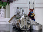Silver Louis Vuitton handbag with double handles and attached shoulder strap