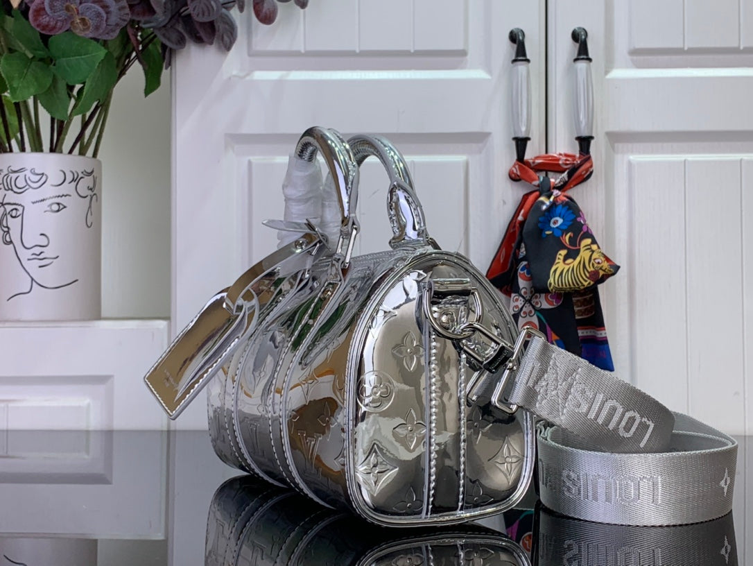 Silver Louis Vuitton handbag with double handles and attached shoulder strap