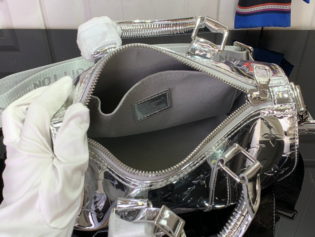 Silver Louis Vuitton handbag interior view with zip top and inner slip pocket