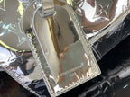 Silver Louis Vuitton handbag side panel with embossed monogram finish