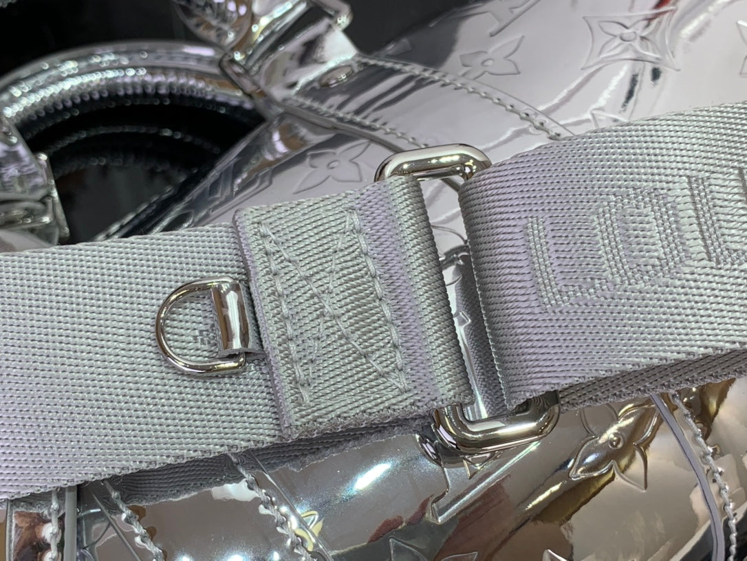 Silver Louis Vuitton handbag with gray jacquard strap and metal buckle hardware