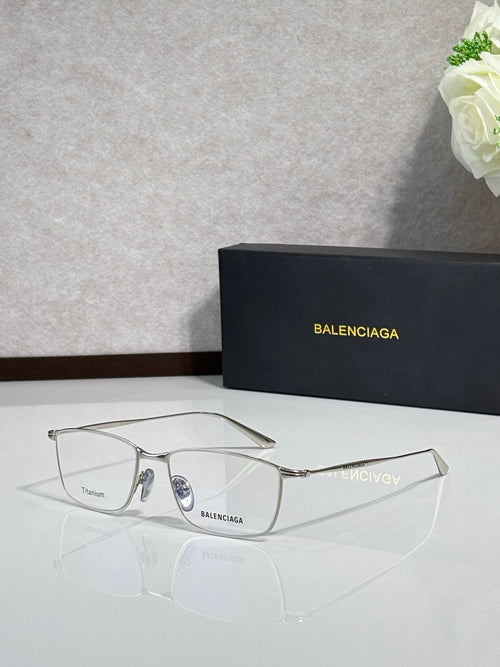 Balenciaga eyeglasses with clear lenses and silver metal frames, mirrored logo detail.