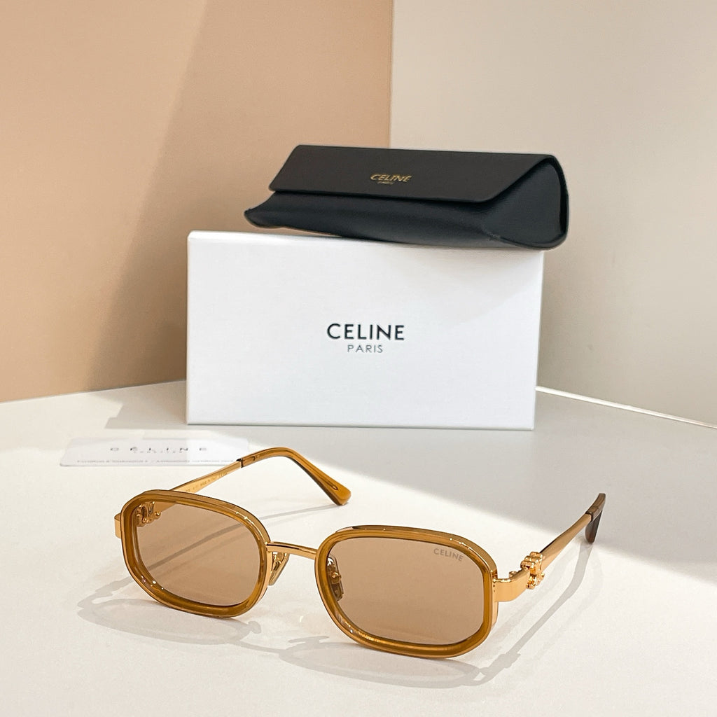 Square sunglasses with light gold frames and tinted brown lenses, temple arms visible