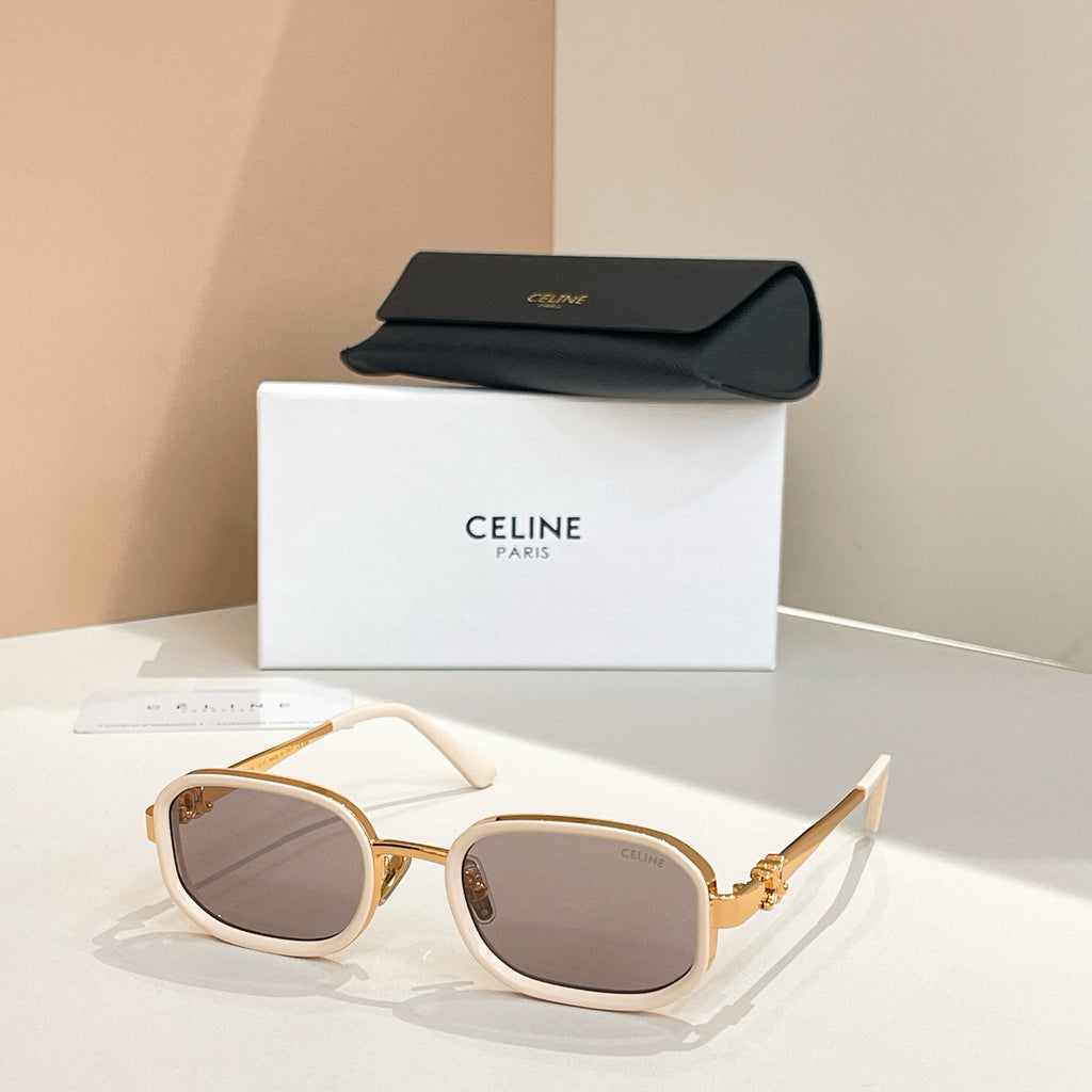 Square sunglasses with gold frames and tinted gray lenses, temple arms visible