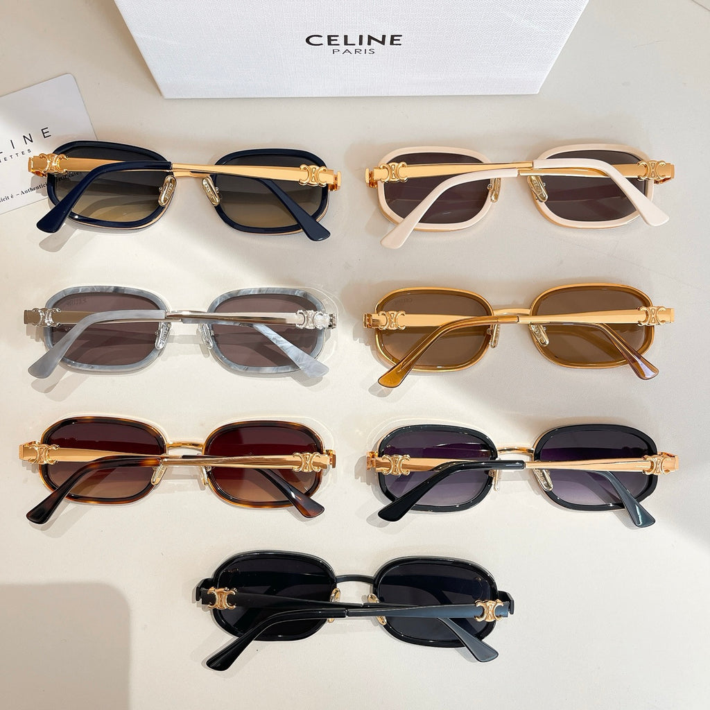 Assorted sunglasses laid out on a surface, with multiple frame colors and tinted lenses