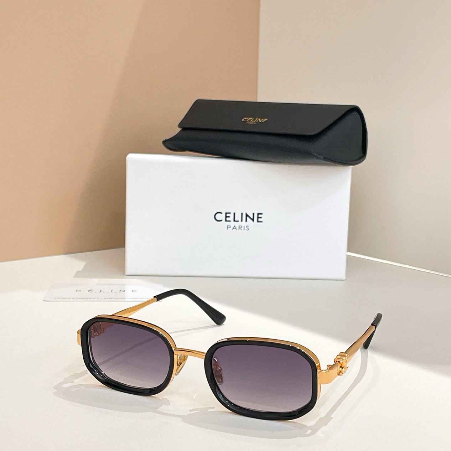 Square sunglasses with tortoiseshell frames and tinted purple lenses, temple arms visible