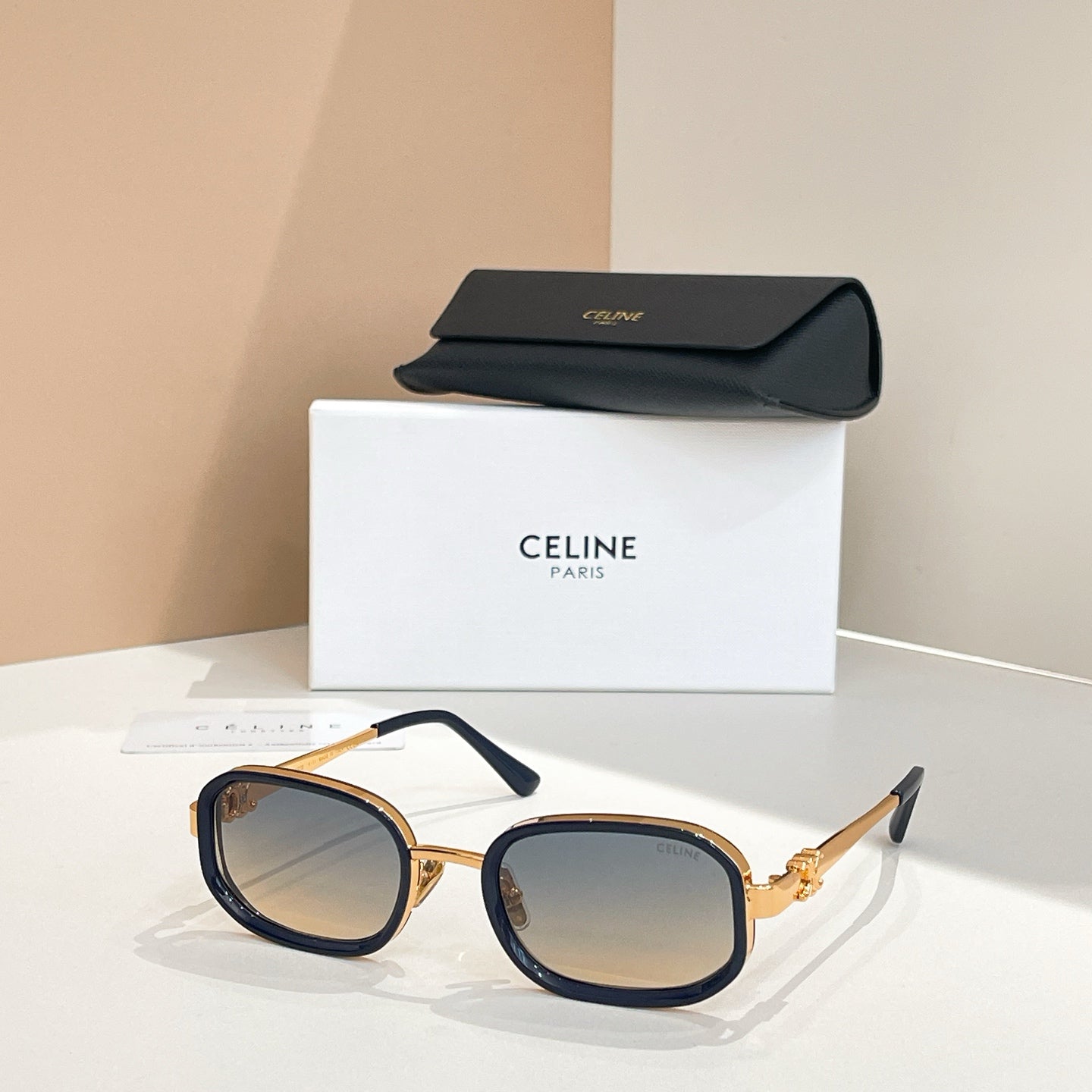 Square sunglasses with dark frames and tinted lenses, temple arms visible