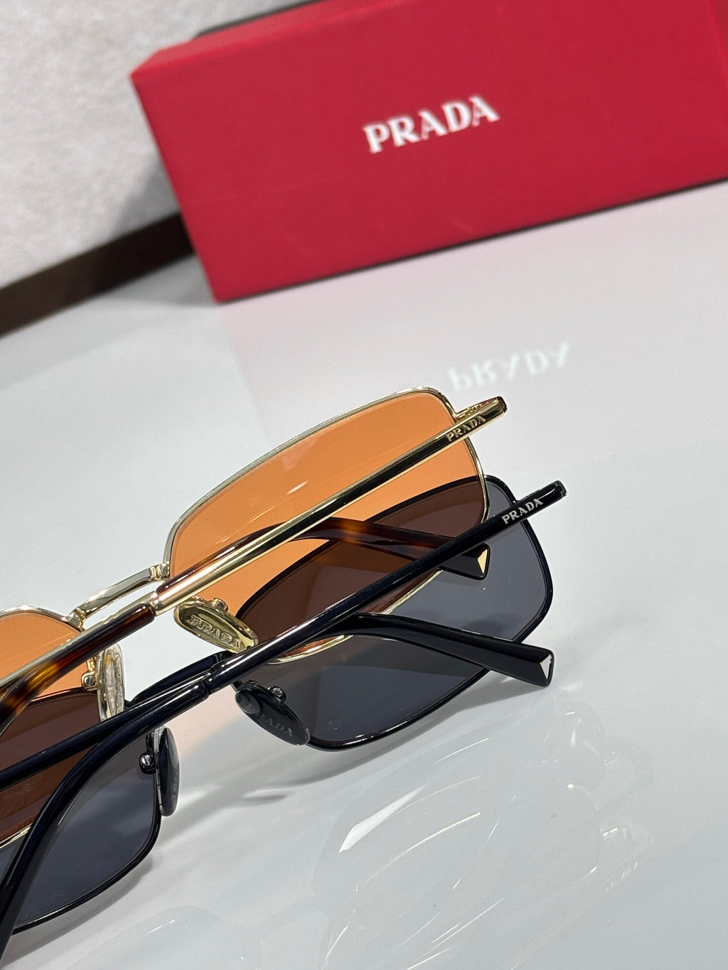 Sunglasses close-up: amber lens and black frame with dark lenses