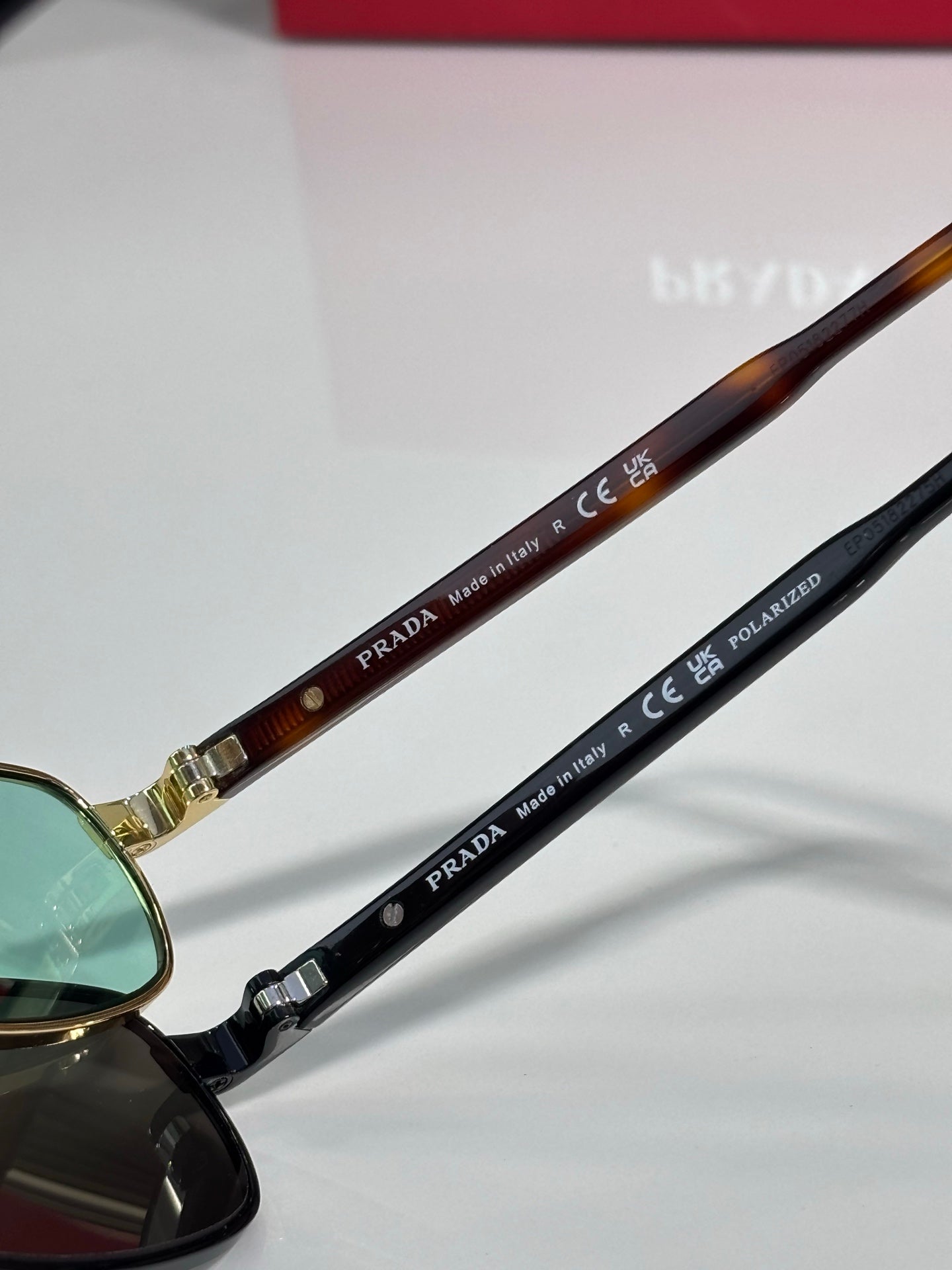 Prada sunglasses temples with 'PRADA' and 'polarized' text