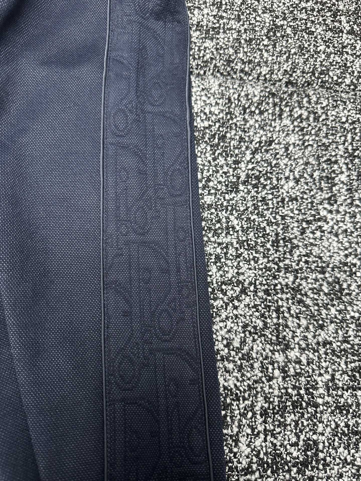 Dior pants side view, slate blue fabric with vertical seam detail