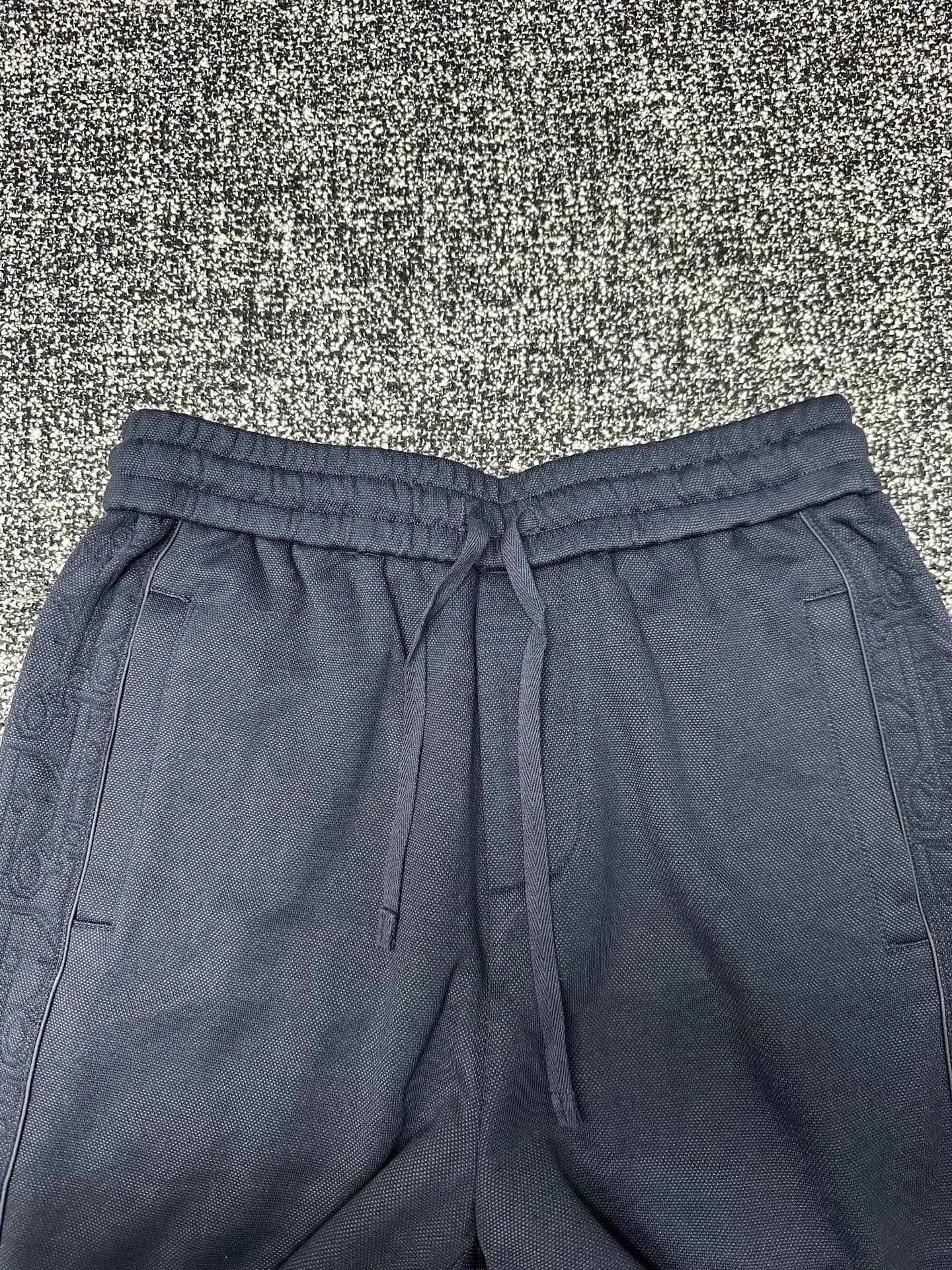Dior pants, slate blue with elastic waistband, drawstring, and side pockets