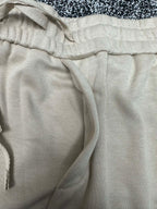 Cream pants close-up of elastic waistband and drawstring cord