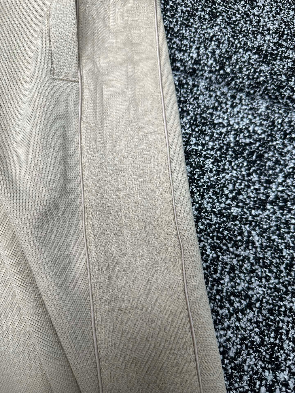 Cream pants close-up of straight side panel and pocket stitching