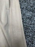 Cream pants close-up of straight side panel and pocket stitching