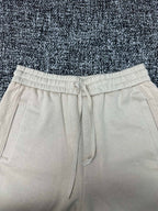 Cream pants with elastic drawstring waist and side pockets, straight fit