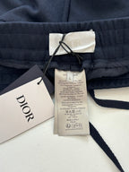 Navy pants with Dior brand label and care tag on elastic waist