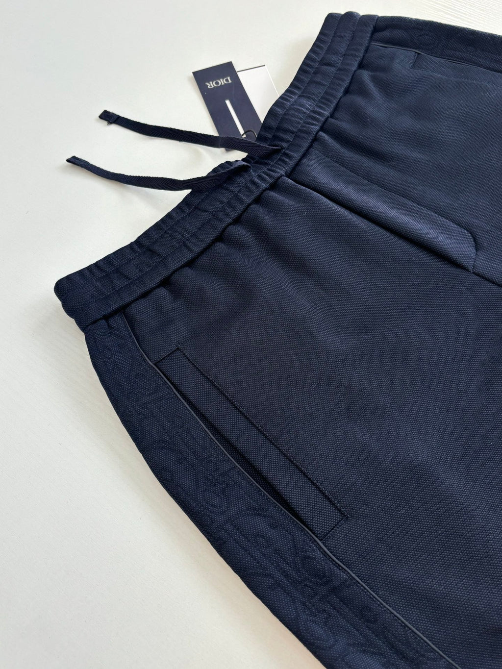 Navy pants with drawstring tie and front pocket seam lines