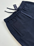 Navy pants with drawstring tie and front pocket seam lines